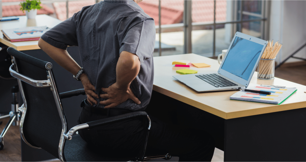 A man working at an office with back pain