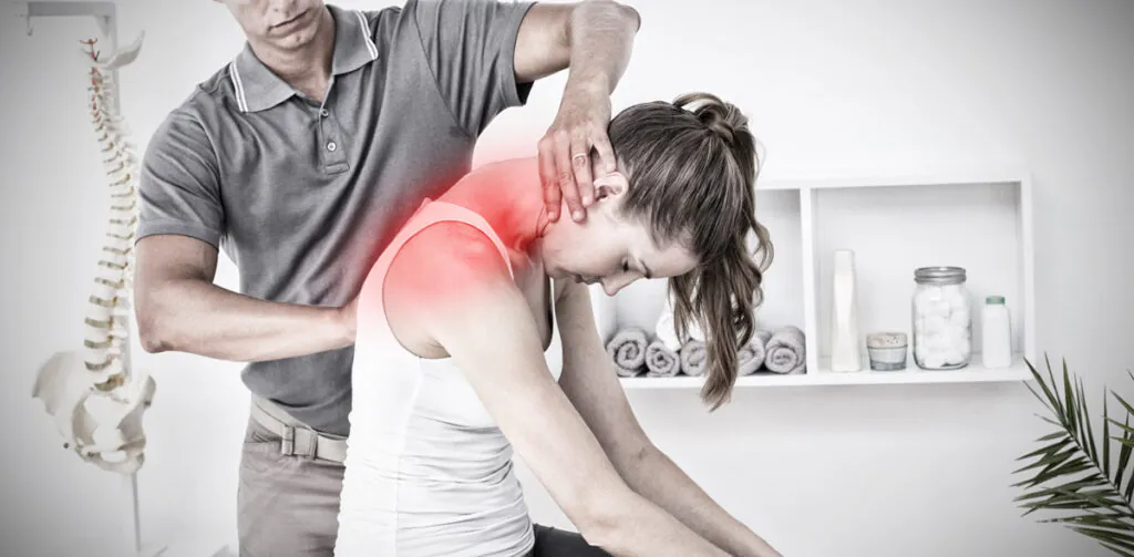 A chiropractor adjusting a woman’s neck in El Paso.